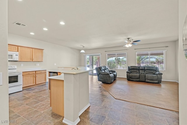 kitchen with light brown cabinets, ceiling fan, white appliances, and light tile patterned floors