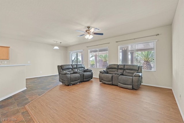 tiled living room with ceiling fan