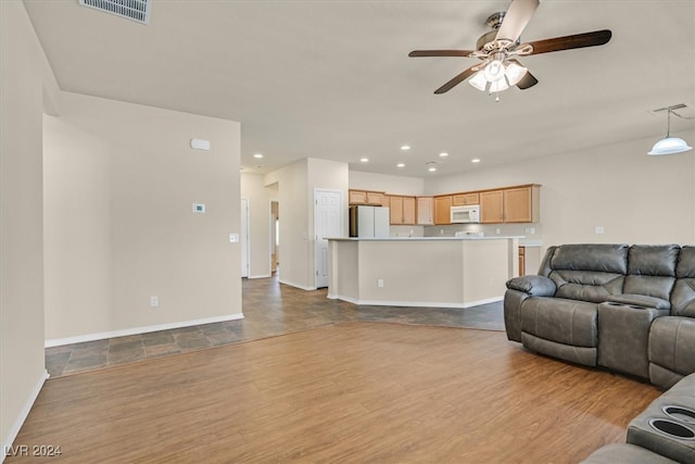 living room featuring light hardwood / wood-style flooring and ceiling fan