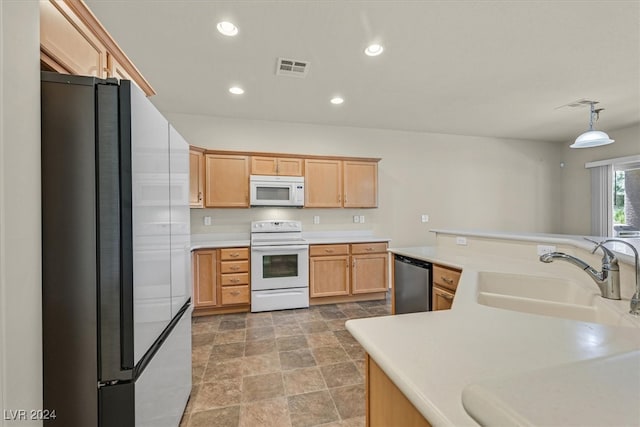 kitchen featuring hanging light fixtures, light brown cabinets, white appliances, sink, and tile patterned flooring