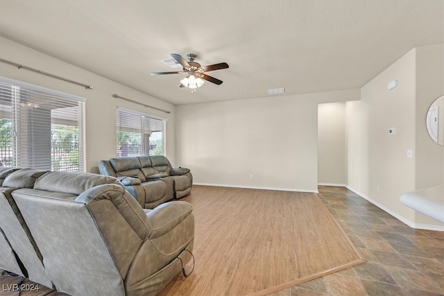 tiled living room featuring ceiling fan