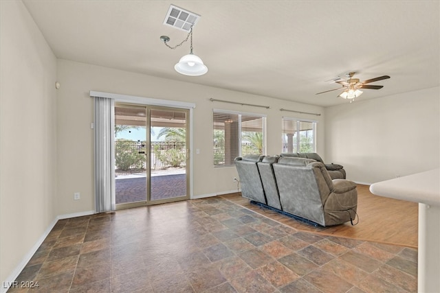 tiled living room with ceiling fan