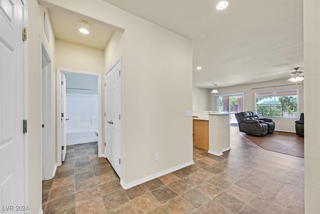 hall with tile patterned floors