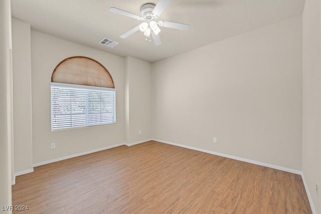 spare room with light wood-type flooring and ceiling fan