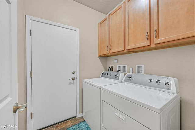 washroom featuring cabinets, separate washer and dryer, and light tile patterned floors