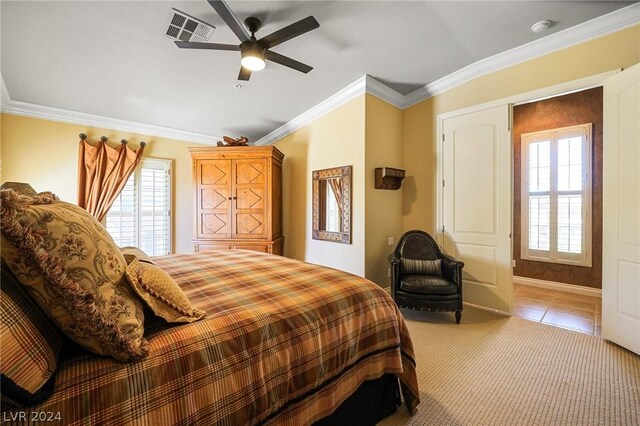 tiled bedroom with ornamental molding and ceiling fan