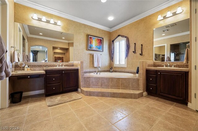 bathroom with tile patterned floors, vanity, crown molding, and tiled bath