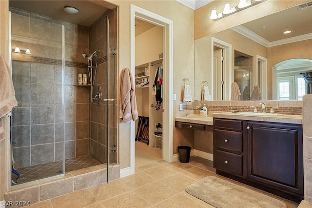 bathroom featuring an enclosed shower, ornamental molding, tasteful backsplash, and vanity