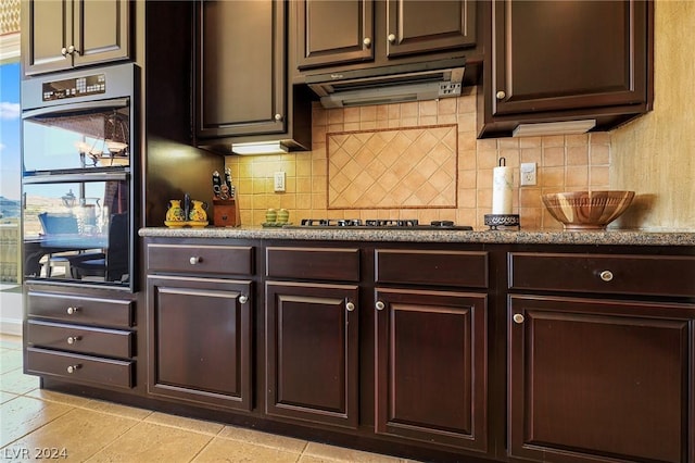 kitchen with backsplash, ventilation hood, dark brown cabinets, and black appliances