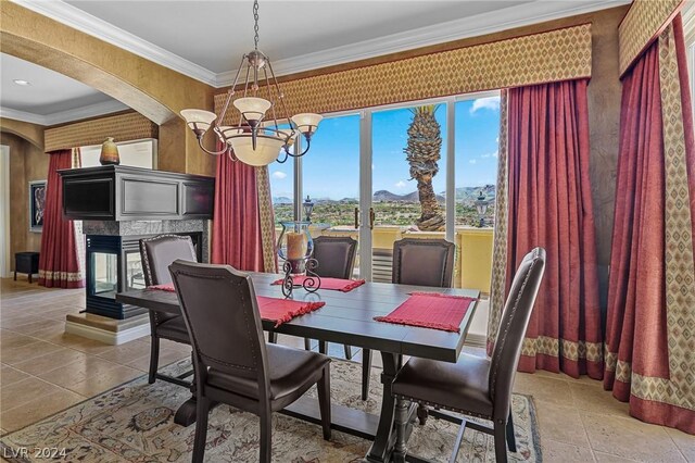 tiled dining room with crown molding, a multi sided fireplace, and a notable chandelier