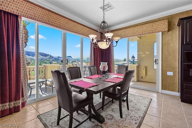 dining space with ornamental molding, a mountain view, and a notable chandelier