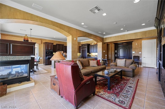 tiled living room with crown molding and a multi sided fireplace