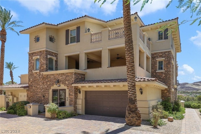 mediterranean / spanish house with a mountain view and a garage