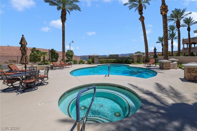 view of pool with a patio area and a community hot tub