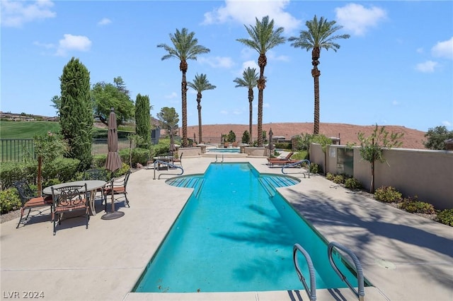 view of pool featuring a patio and a mountain view