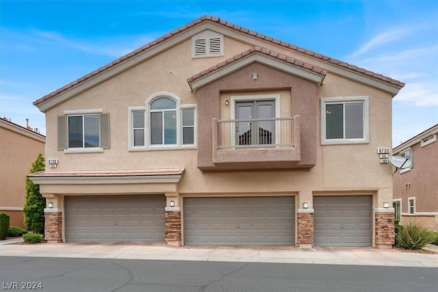 multi unit property featuring a garage and a balcony