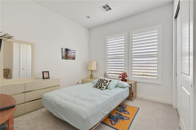 carpeted bedroom featuring a closet