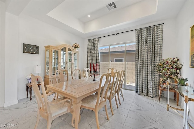 dining area featuring a raised ceiling