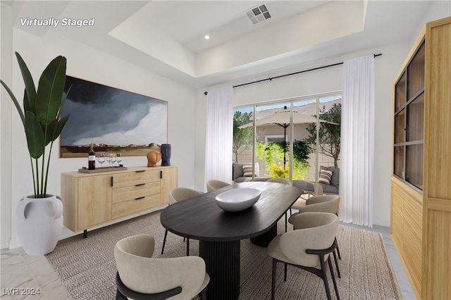 dining space featuring a tray ceiling