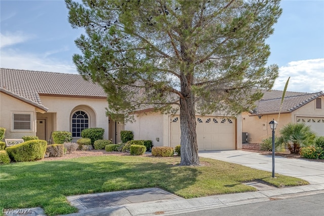 view of front facade with a garage and a front yard