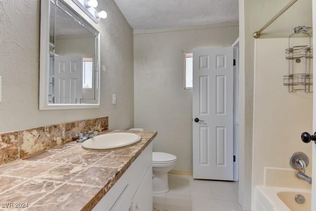 bathroom featuring a textured ceiling,  shower combination, vanity, and a healthy amount of sunlight