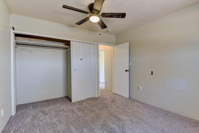 unfurnished bedroom featuring carpet, a closet, and ceiling fan