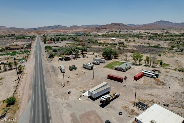 birds eye view of property with view of desert and a mountain view