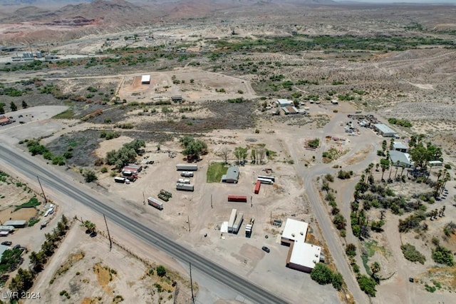 drone / aerial view with view of desert, a rural view, and a mountain view