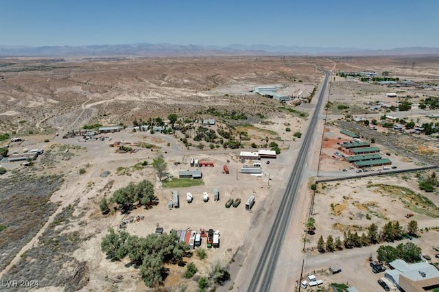 aerial view featuring a mountain view and view of desert