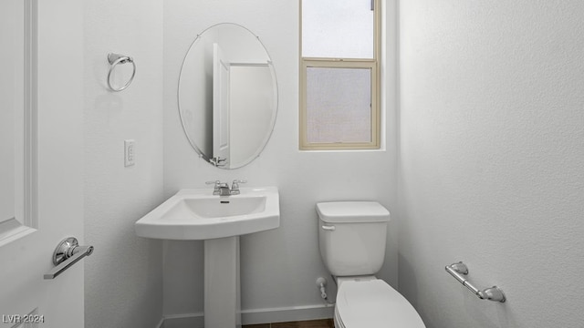 bathroom with toilet and a sink