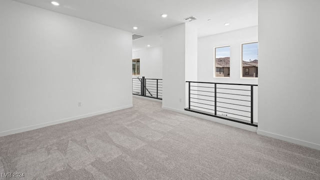 spare room featuring recessed lighting, visible vents, and carpet