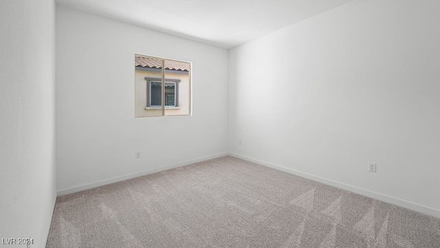 carpeted empty room with baseboards