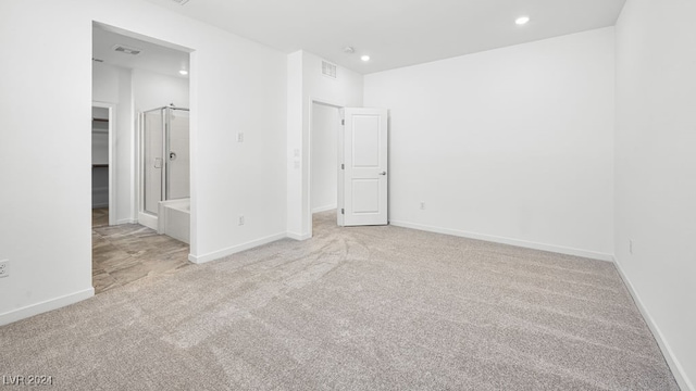 unfurnished bedroom featuring carpet, a spacious closet, recessed lighting, and baseboards