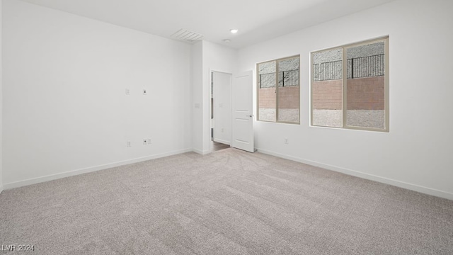 unfurnished room featuring recessed lighting, visible vents, light carpet, and baseboards