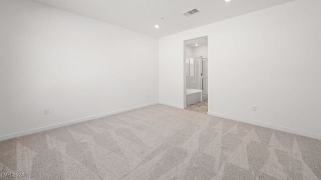 spare room with visible vents, recessed lighting, baseboards, and light carpet