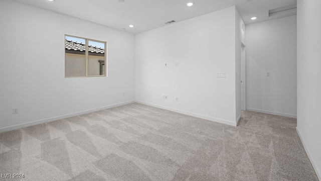 carpeted empty room featuring recessed lighting, visible vents, and baseboards