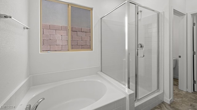 bathroom featuring toilet, a stall shower, and a bath