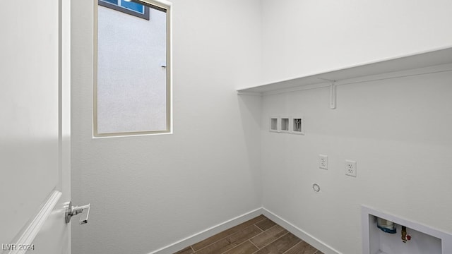 washroom with washer hookup, hookup for a gas dryer, baseboards, dark wood-style flooring, and laundry area