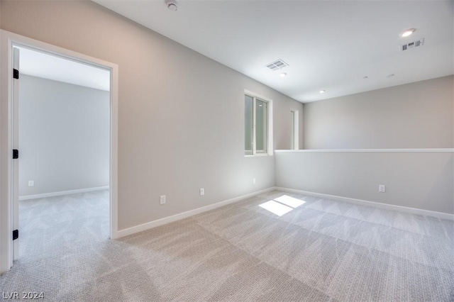 spare room with light colored carpet