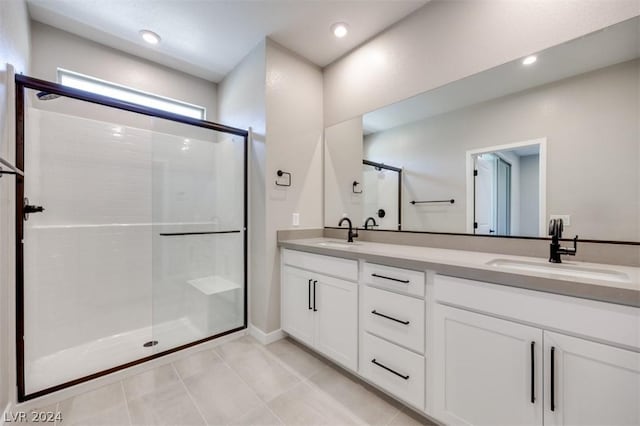 bathroom with vanity, tile patterned flooring, and a shower with door