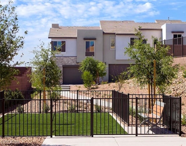 view of front of property with a garage and a front yard