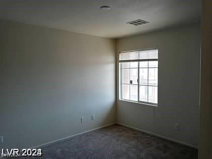 4085 Oliver Sagebrush Dr, Las Vegas, NV 89122 - empty room featuring dark carpet and baseboards
