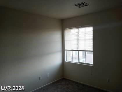 4085 Oliver Sagebrush Dr, Las Vegas, NV 89122 - spare room with dark colored carpet and baseboards