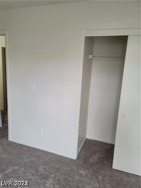 unfurnished bedroom with a closet and carpet