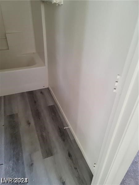 bathroom featuring shower / bath combination and hardwood / wood-style flooring