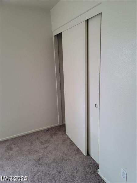 unfurnished bedroom featuring a closet and carpet flooring