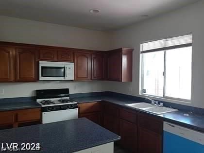 kitchen featuring white appliances and sink