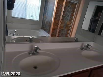 4085 Oliver Sagebrush Dr, Las Vegas, NV 89122 - full bathroom with double vanity and a bathtub