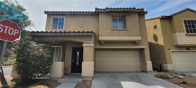 4085 Oliver Sagebrush Dr, Las Vegas, NV 89122 - view of front facade featuring an attached garage, stucco siding, driveway, and a tiled roof