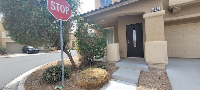4085 Oliver Sagebrush Dr, Las Vegas, NV 89122 - view of exterior entry with stucco siding and a garage